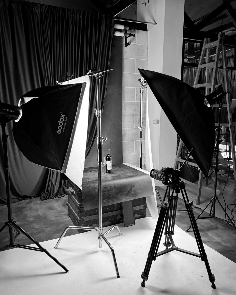 Product photography setup with softboxes and wine bottle