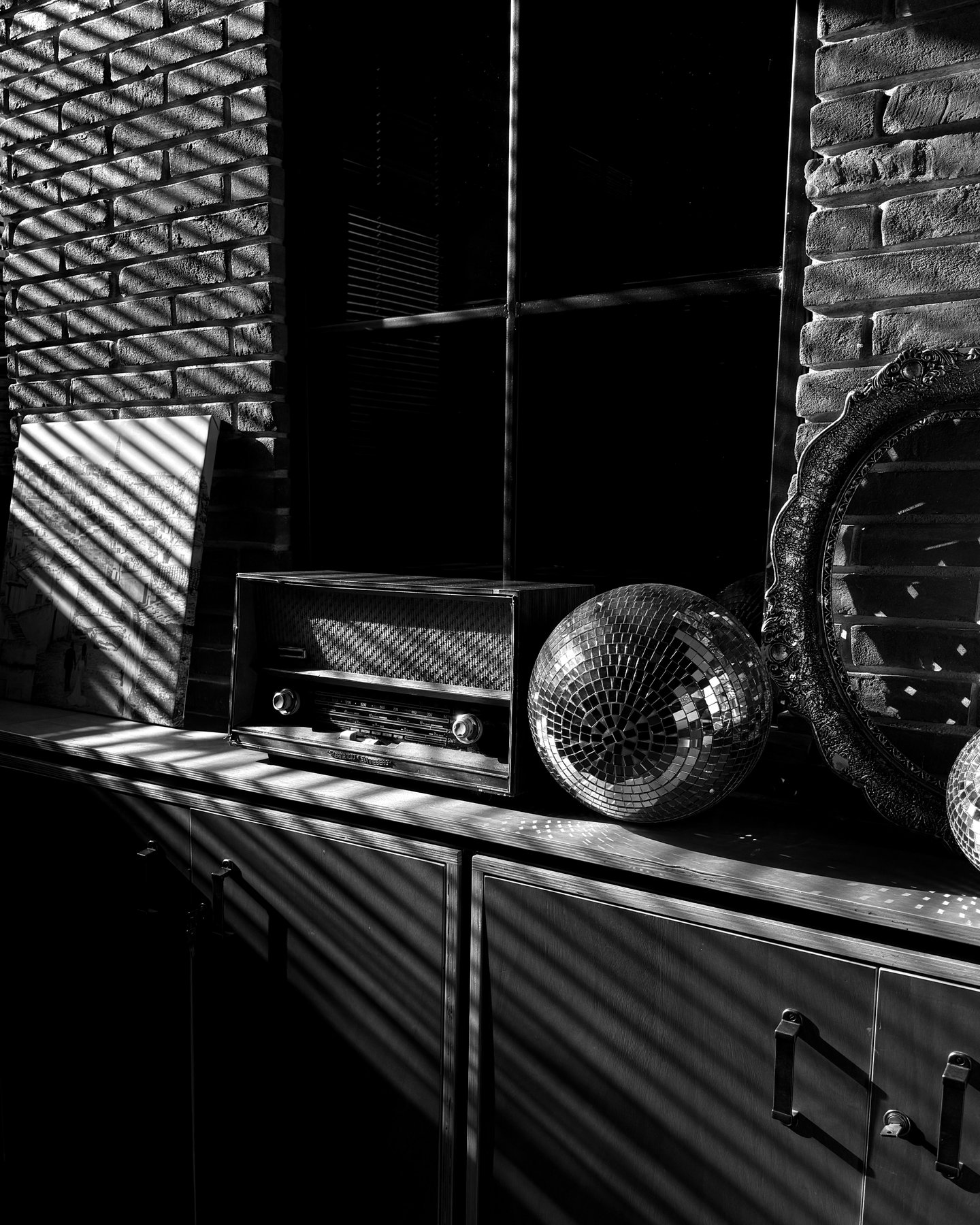 Vintage radio and disco ball still life against exposed brick