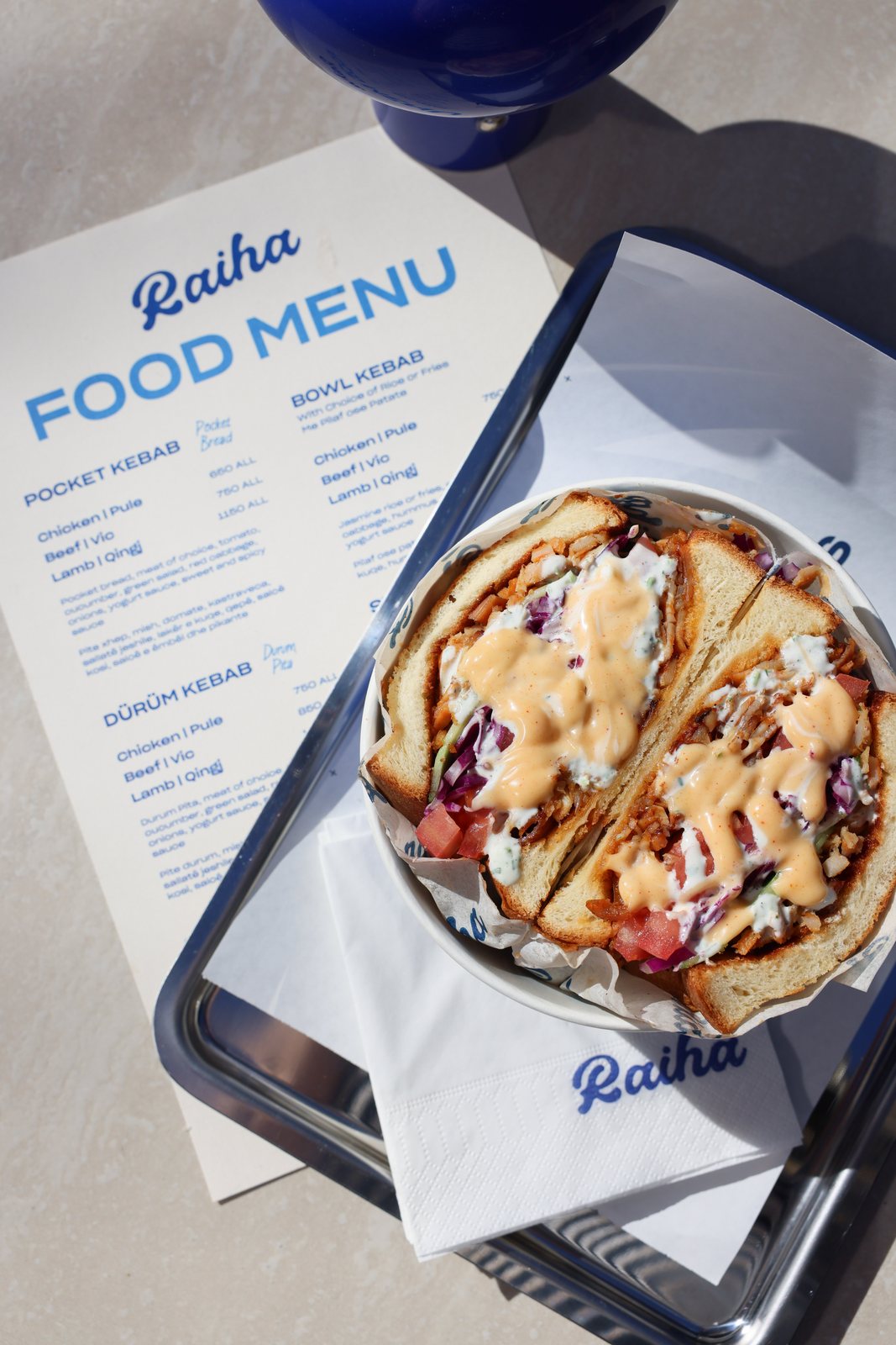 Raiha pocket kebab on a tray with the food menu