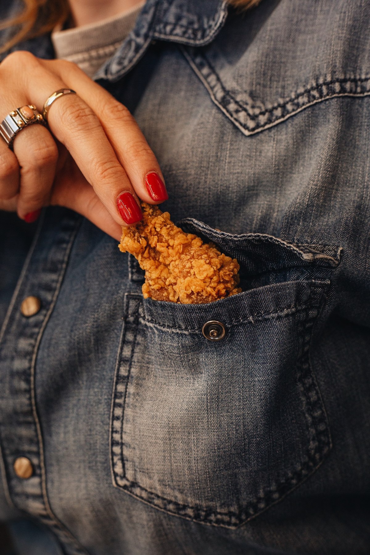 Crispy chicken tucked into the pocket of a denim shirt