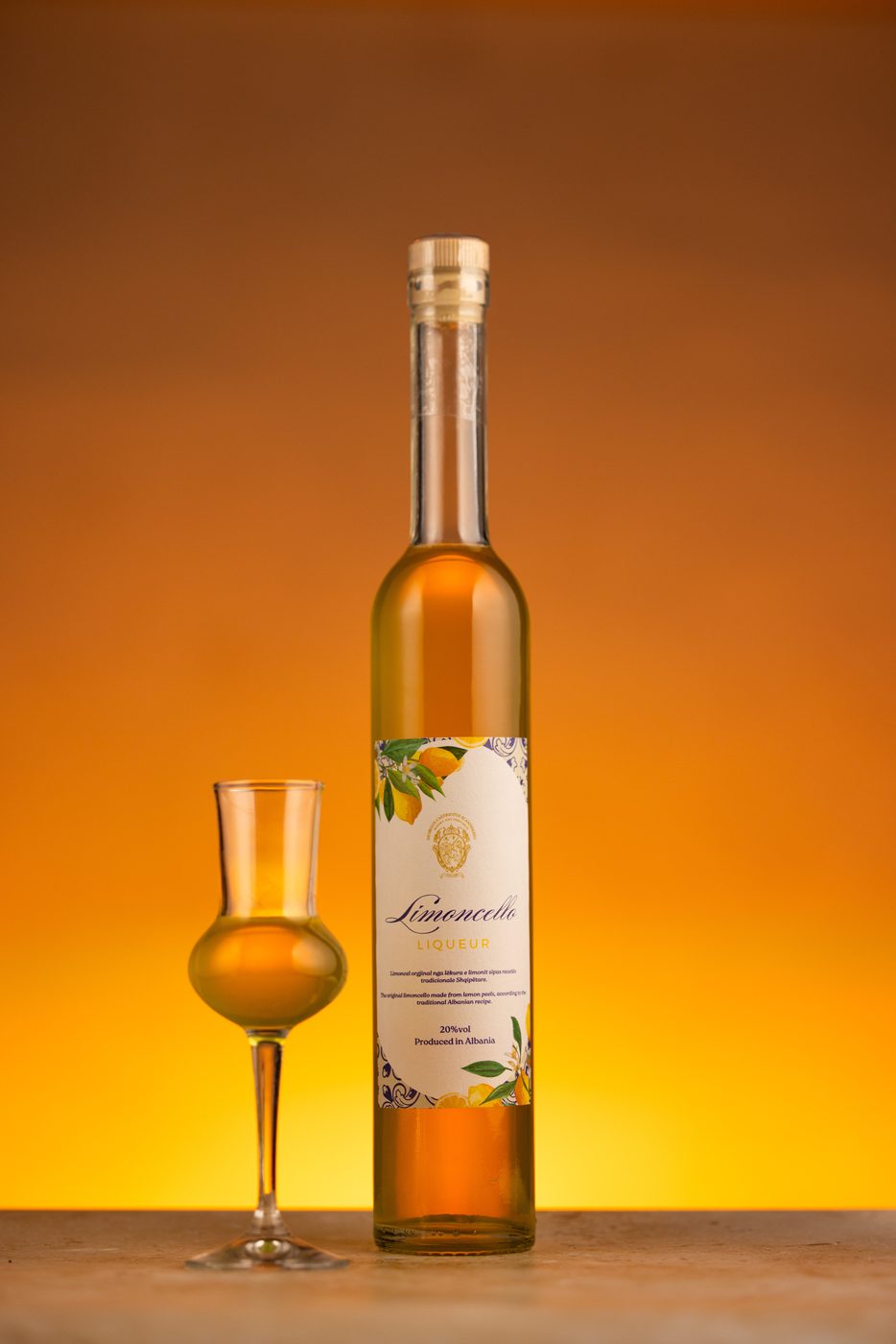 Limoncello liqueur with a glass on orange