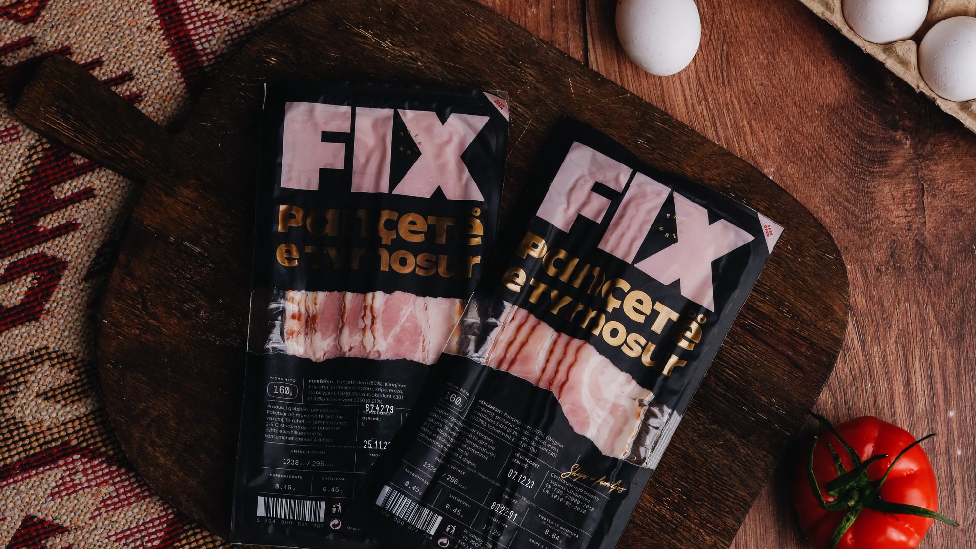 FIX smoked pancetta packs on a breakfast table with bread, eggs and coffee