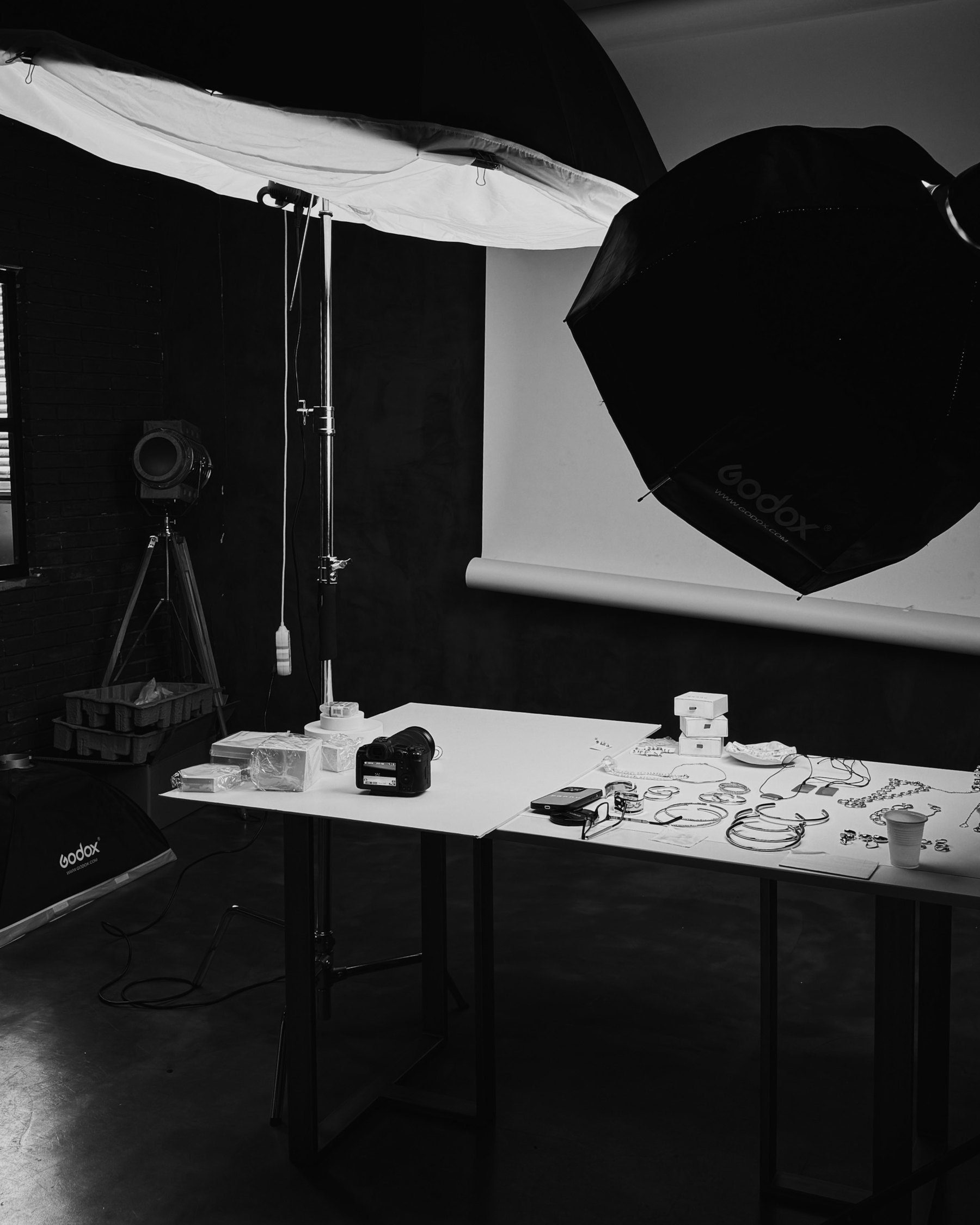 The studio set up for a product shoot, with softboxes, backdrop and a styling table