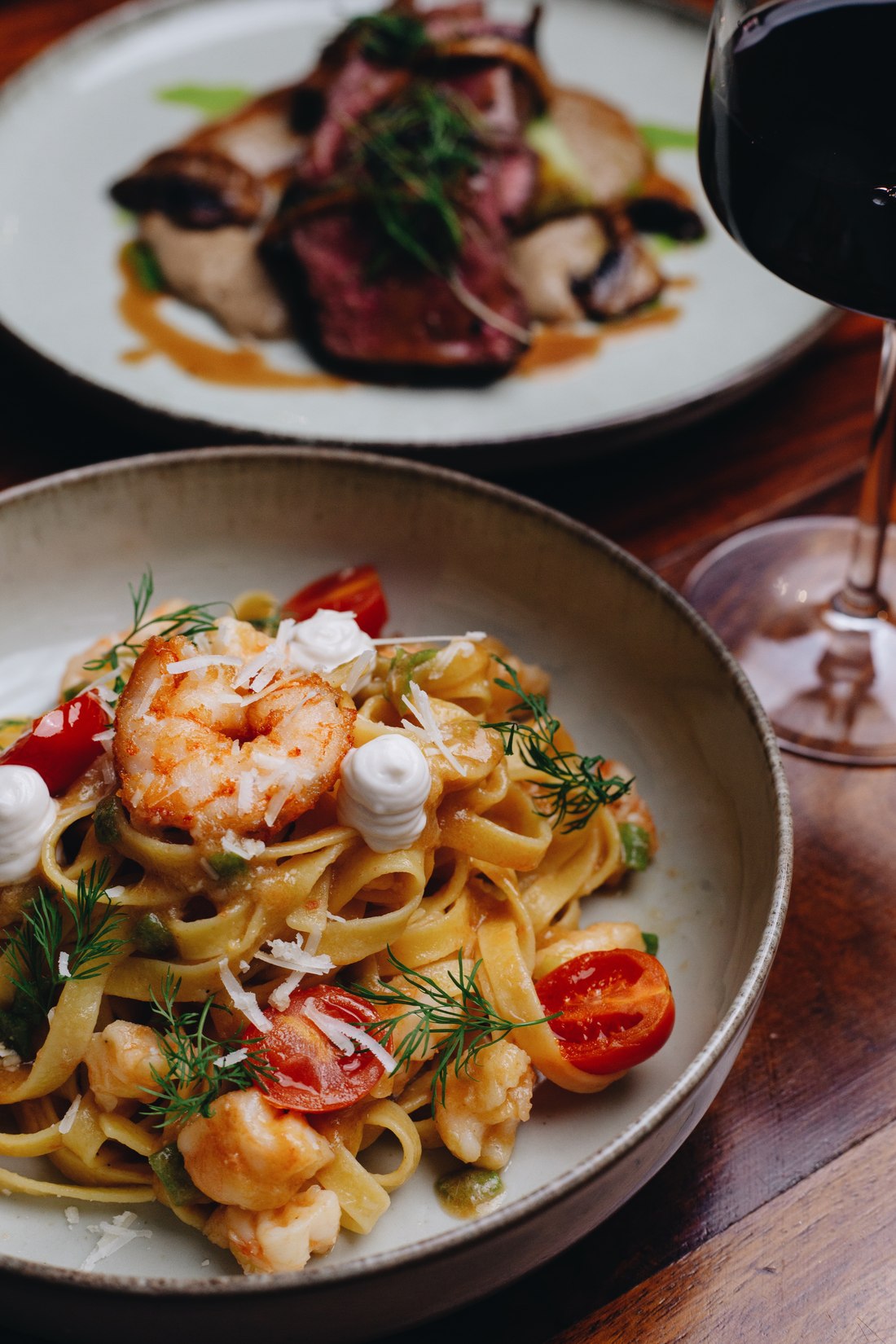 Prawn tagliatelle and steak with a glass of red wine