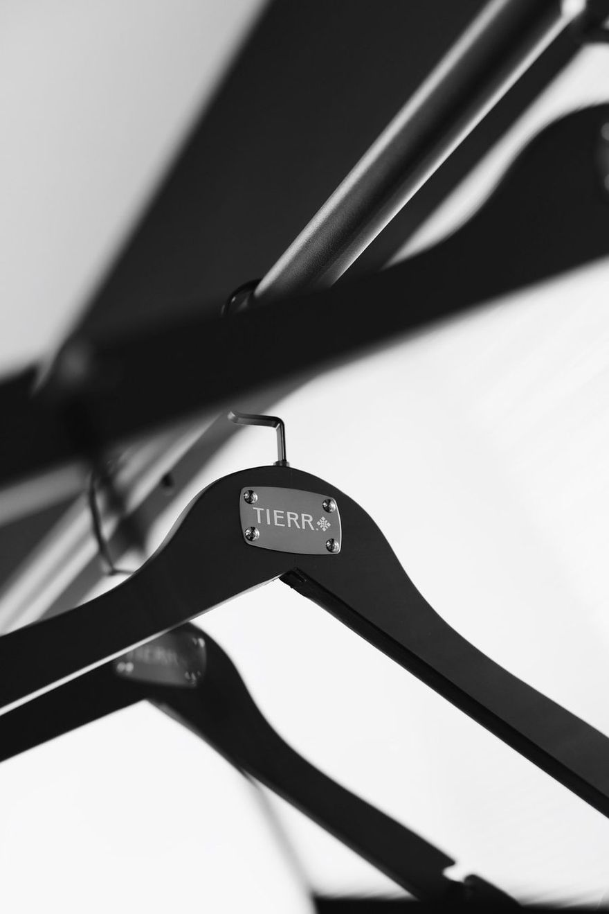 Black TIERR hanger with a metal logo plate
