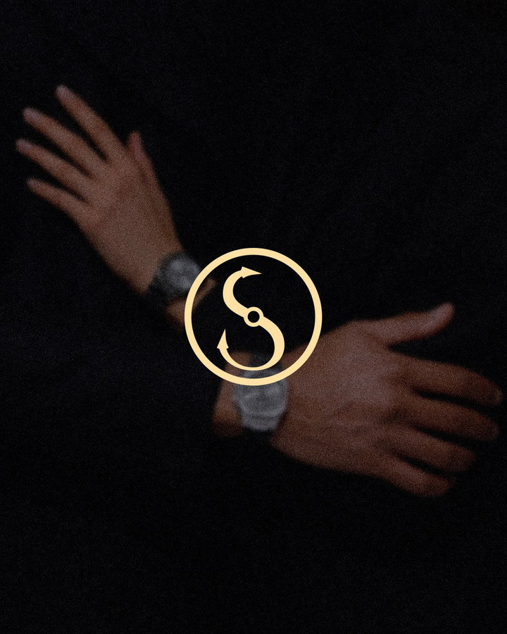 Select Watches gold S logo over crossed wrists wearing watches