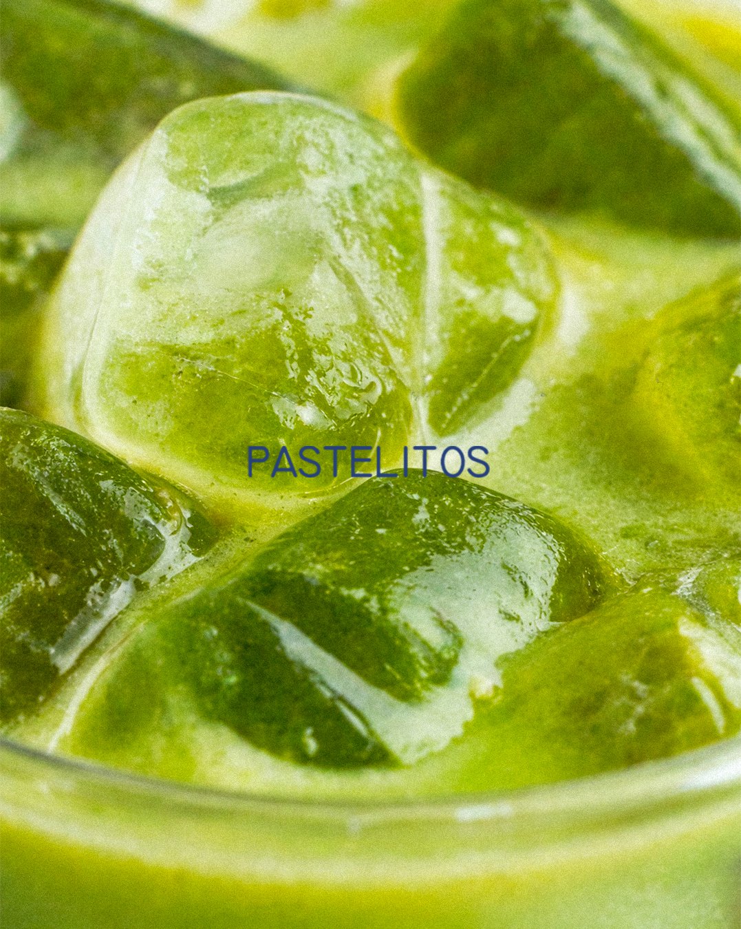 Iced matcha close-up with the Pastelitos wordmark