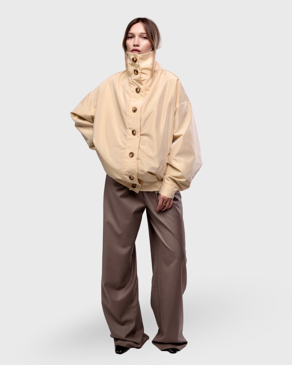 Cream bomber worn with brown trousers