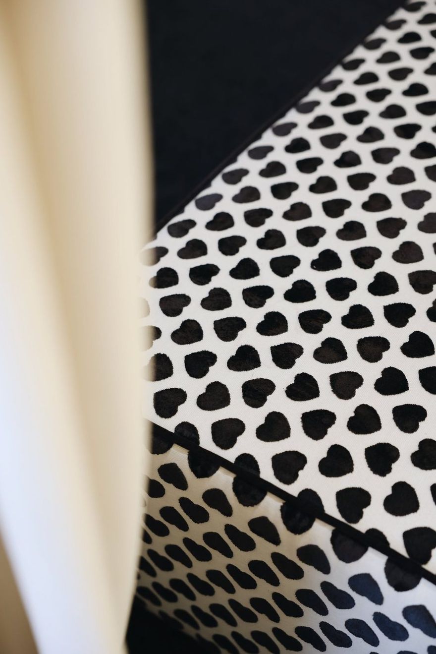 Close-up of black heart print fabric in the TIERR atelier