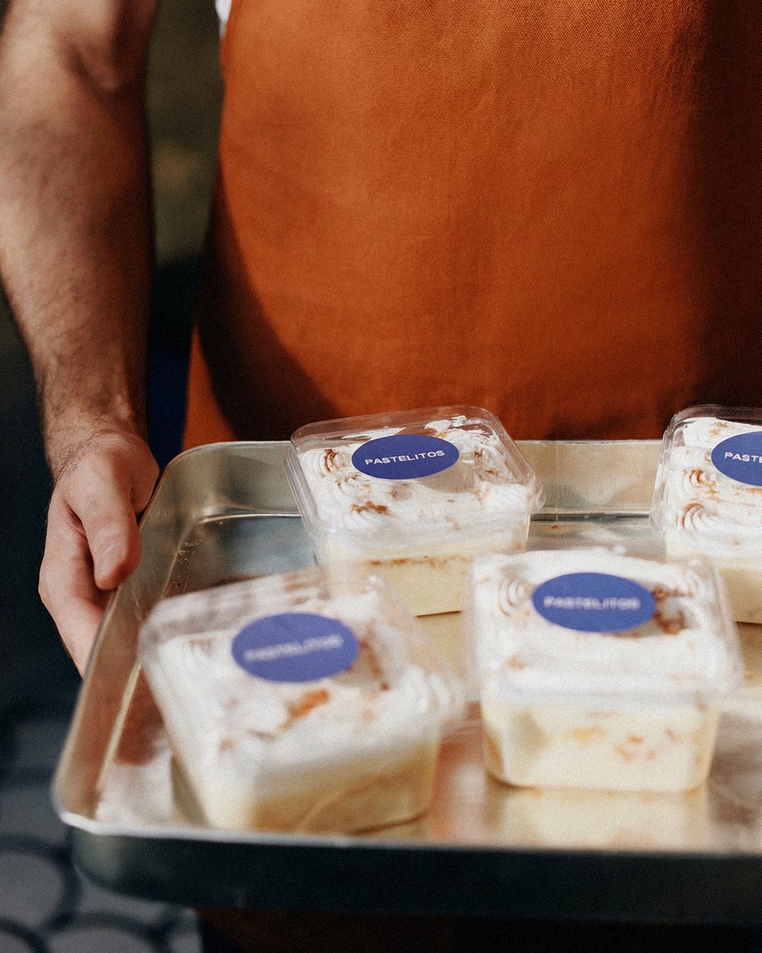 Tray of tres leches cups with Pastelitos stickers