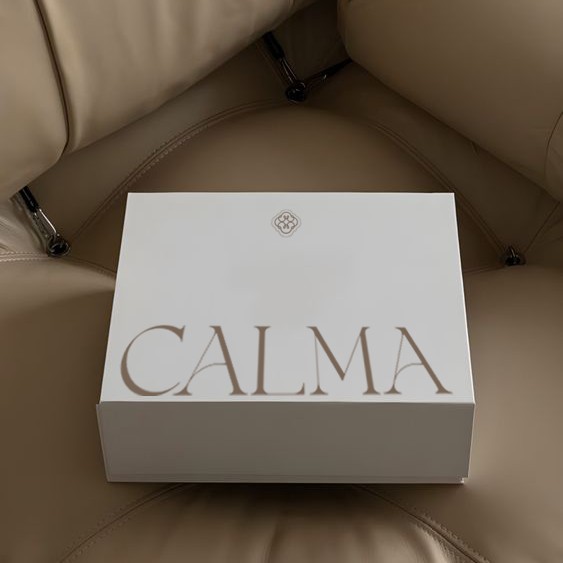 White Calma towel box on a beige leather sofa
