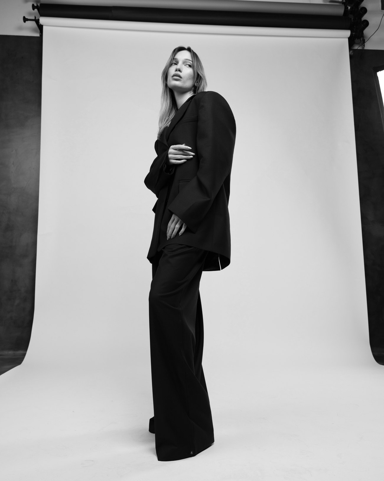 Black and white editorial portrait of the oversized DOOR 903 suit