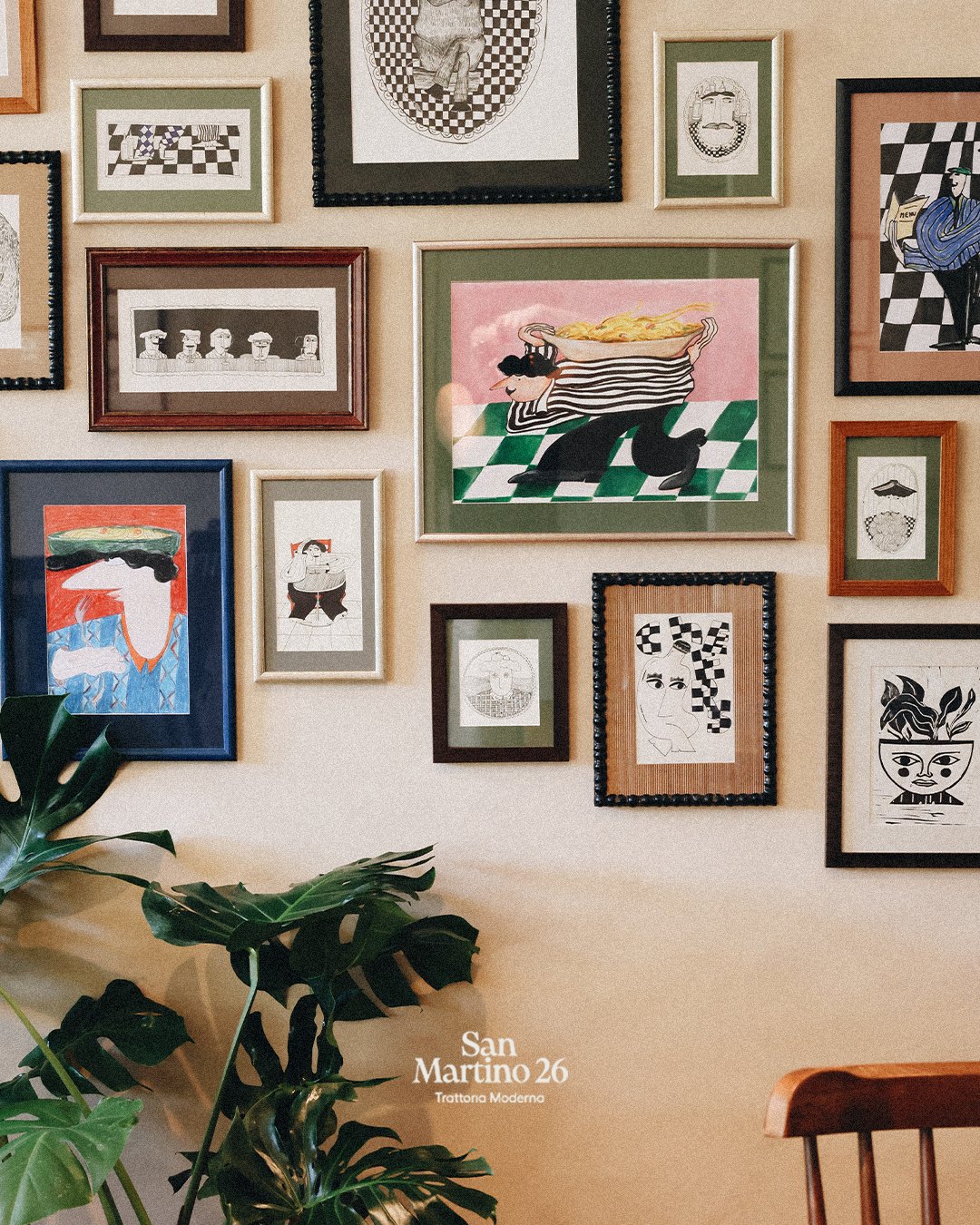 Gallery wall of framed illustrations in the dining room