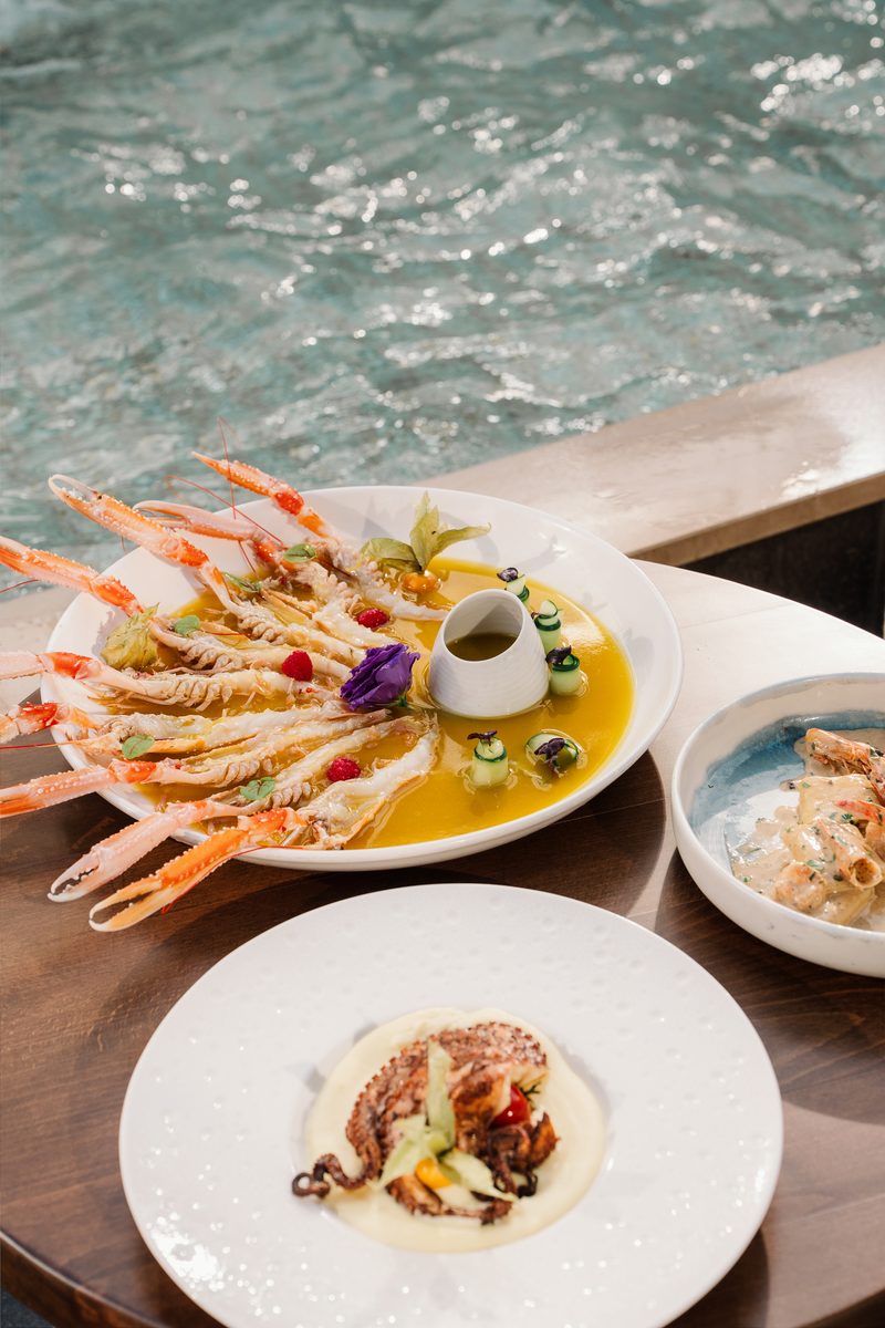 Langoustines, octopus and pasta served by the pool