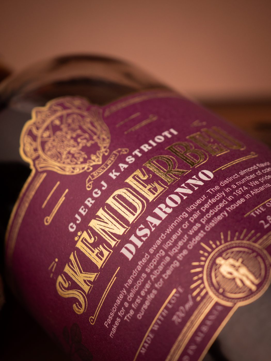 Skënderbeu Disaronno label close-up in gold foil