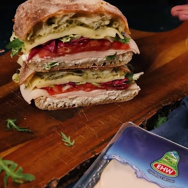 Stacked ciabatta sandwich with EHW chicken breast beside the pack