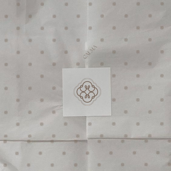 Calma tissue wrapping paper with monogram pattern and logo card