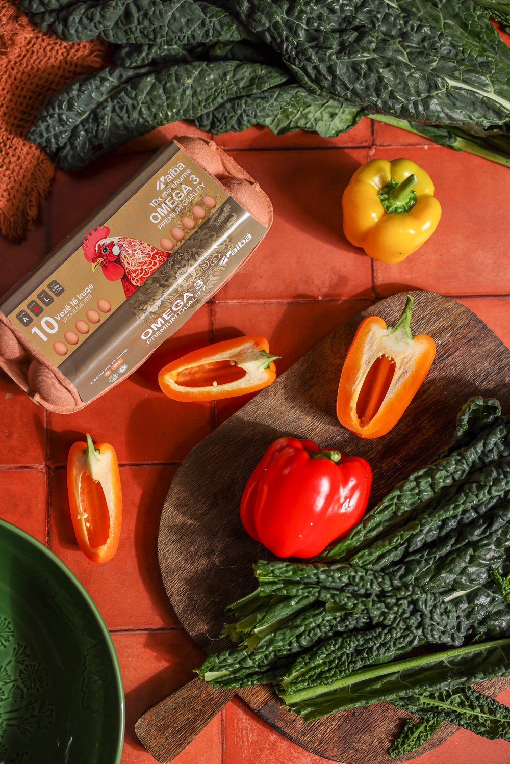 AIBA Omega 3 carton with peppers and kale on a terracotta table