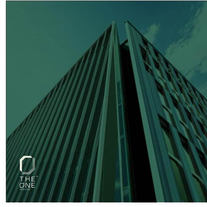 The One Residence tower viewed from below, diagonal glass facade against the sky