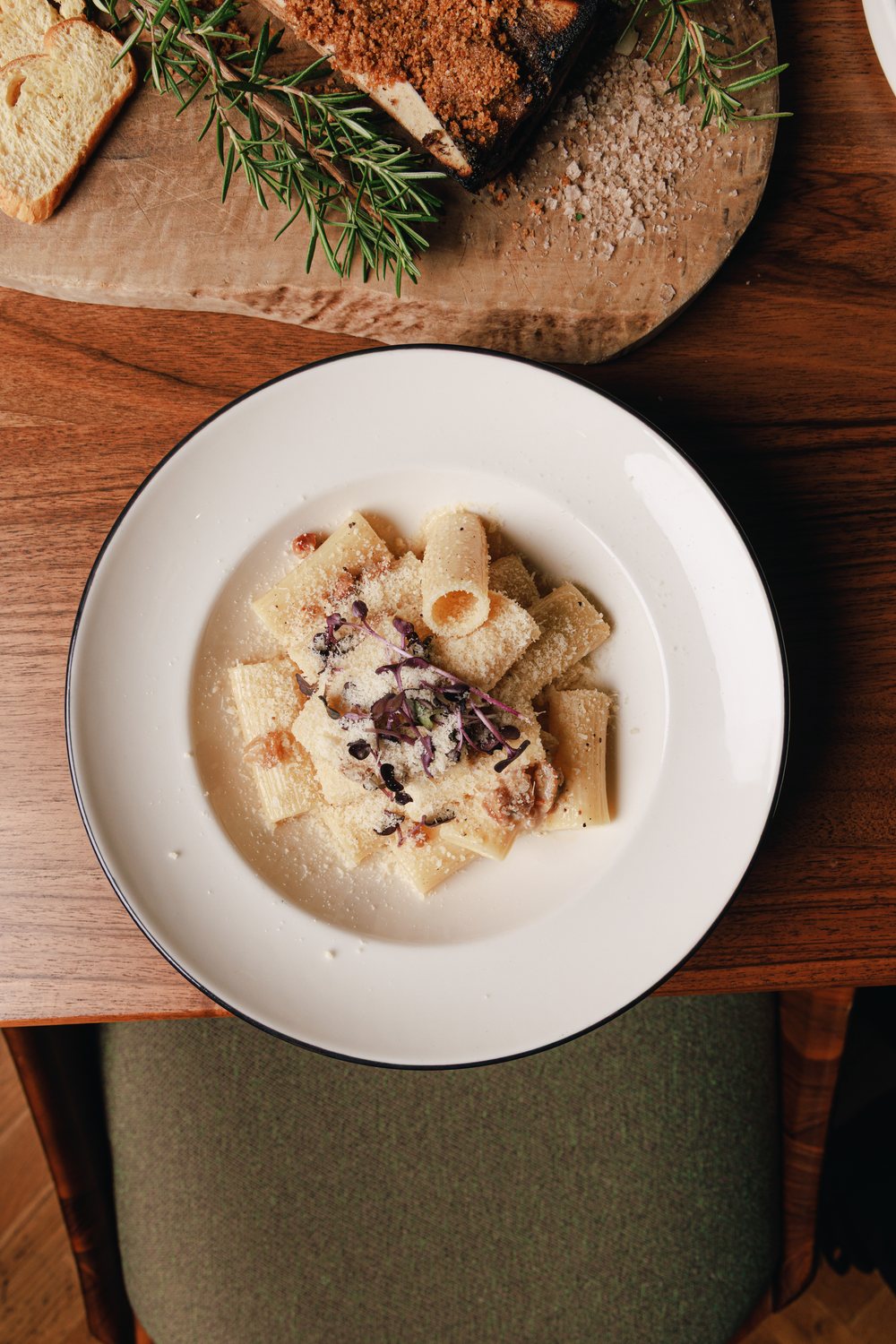 Rigatoni with parmesan and micro herbs, beside roasted bone marrow and bread
