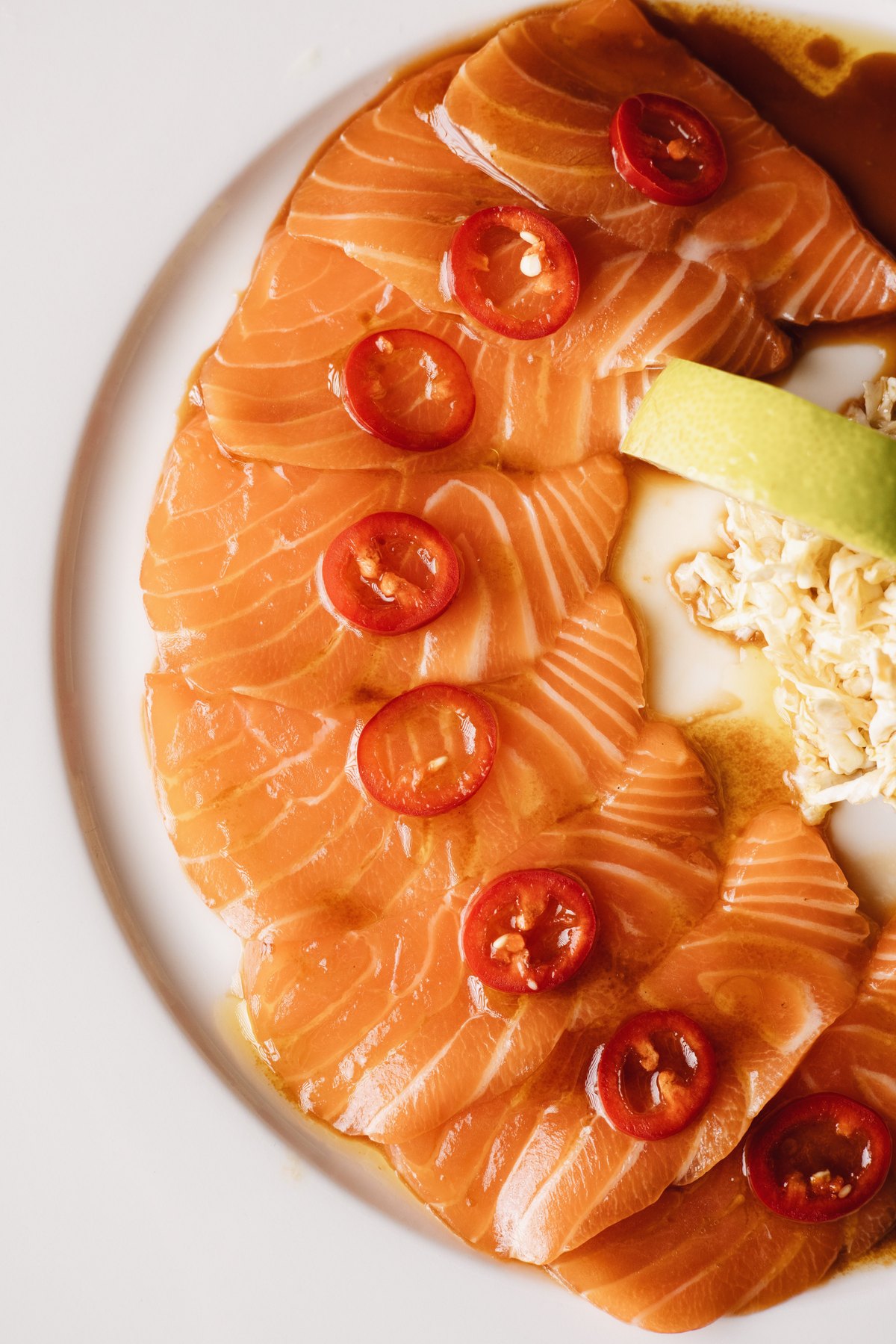 Salmon carpaccio with sliced red chilli and lime