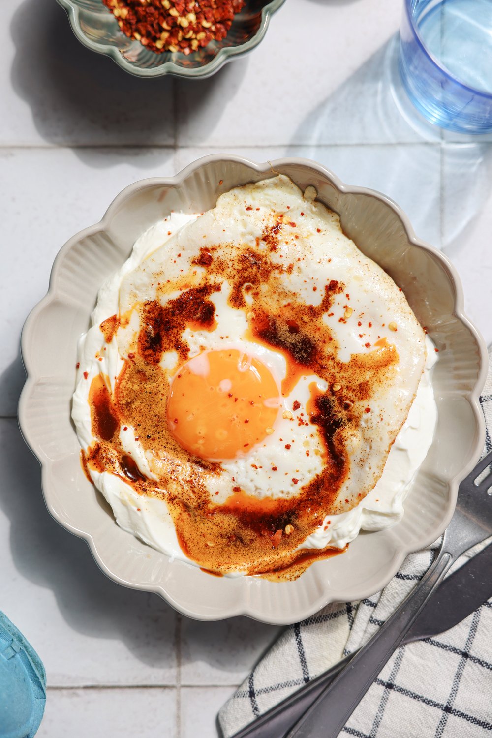 Close-up of cilbir: fried egg over yogurt with chilli butter