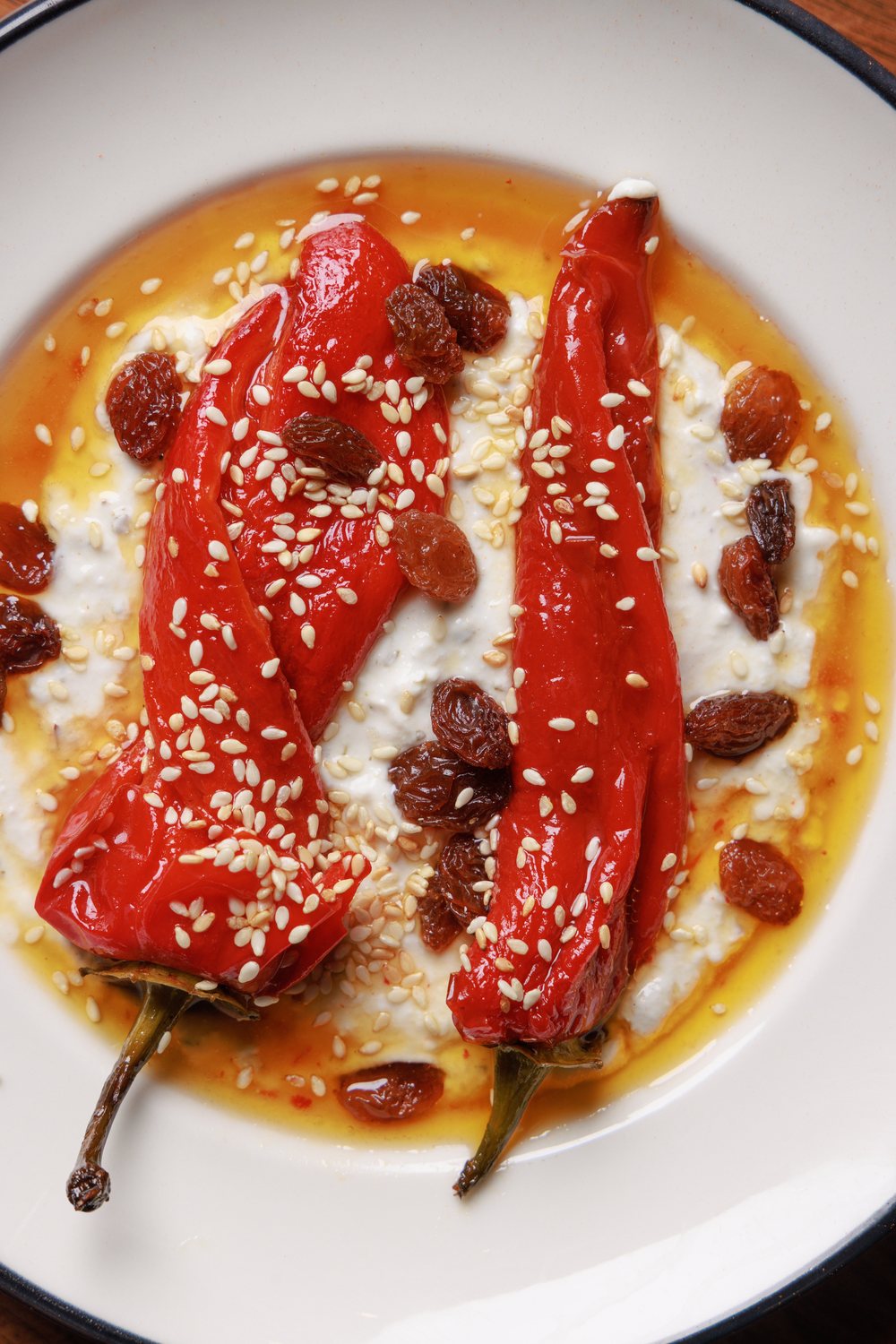 Roasted red peppers with whipped cheese, sesame and golden raisins