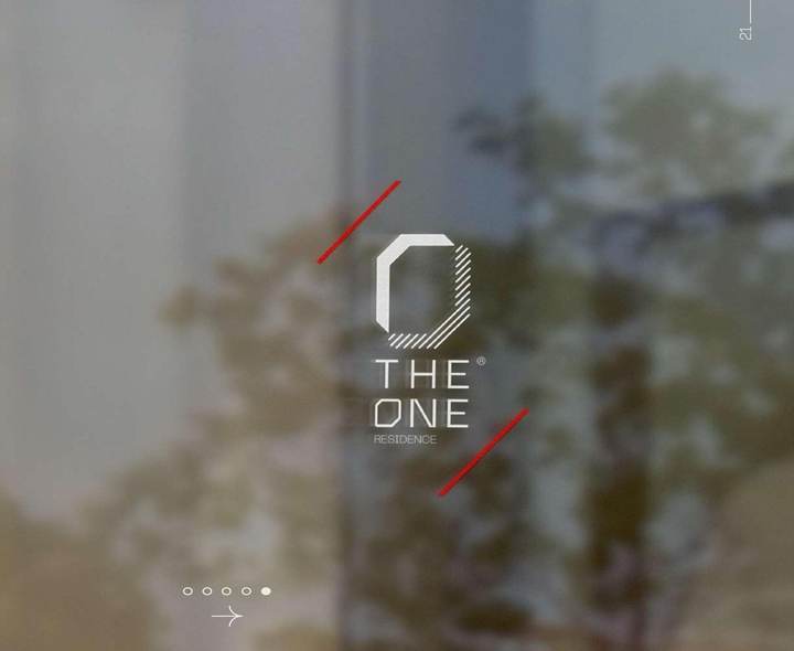 The One wordmark etched on a glass facade, reflecting trees and daylight