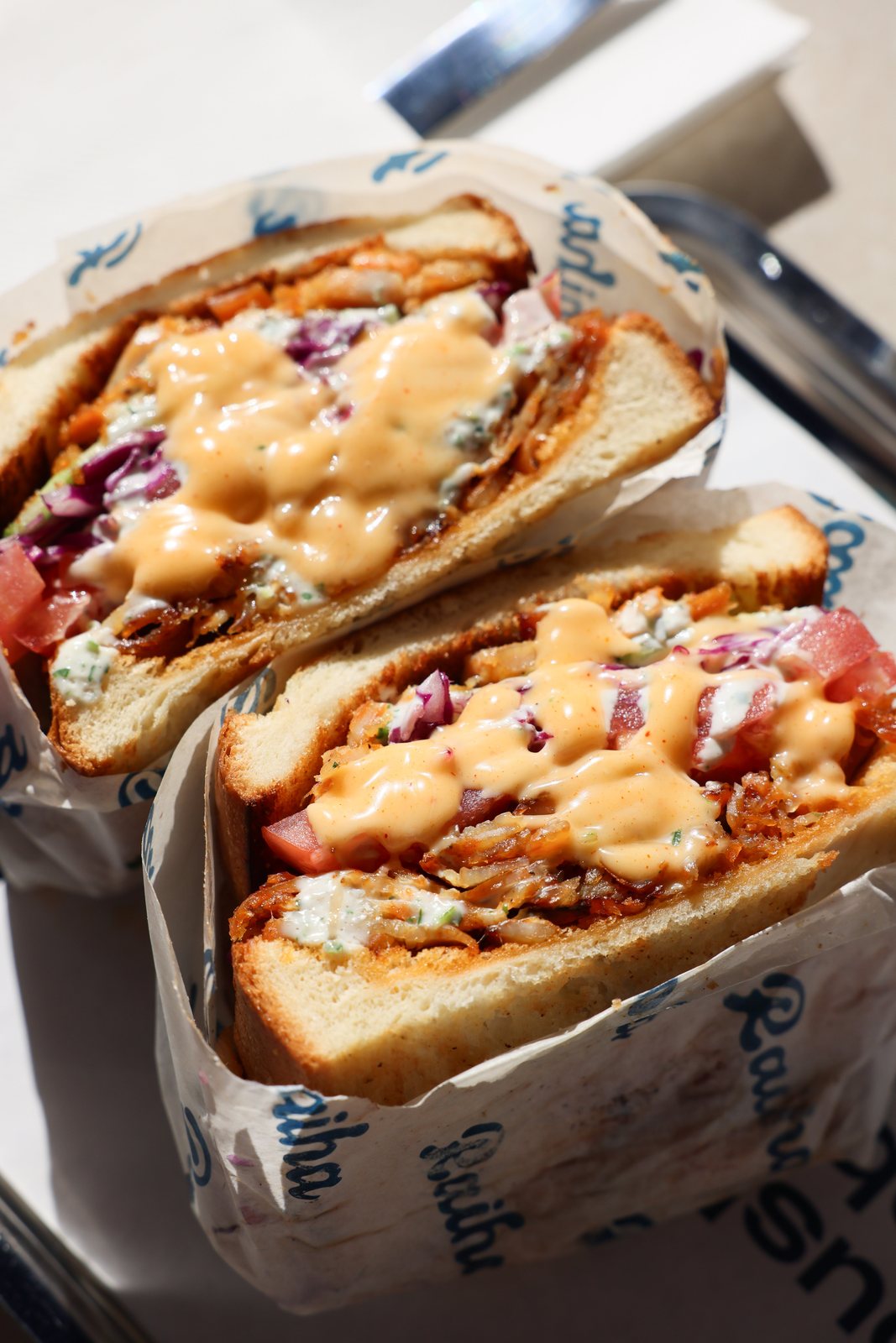 Close-up of Raiha pocket kebabs wrapped in branded paper