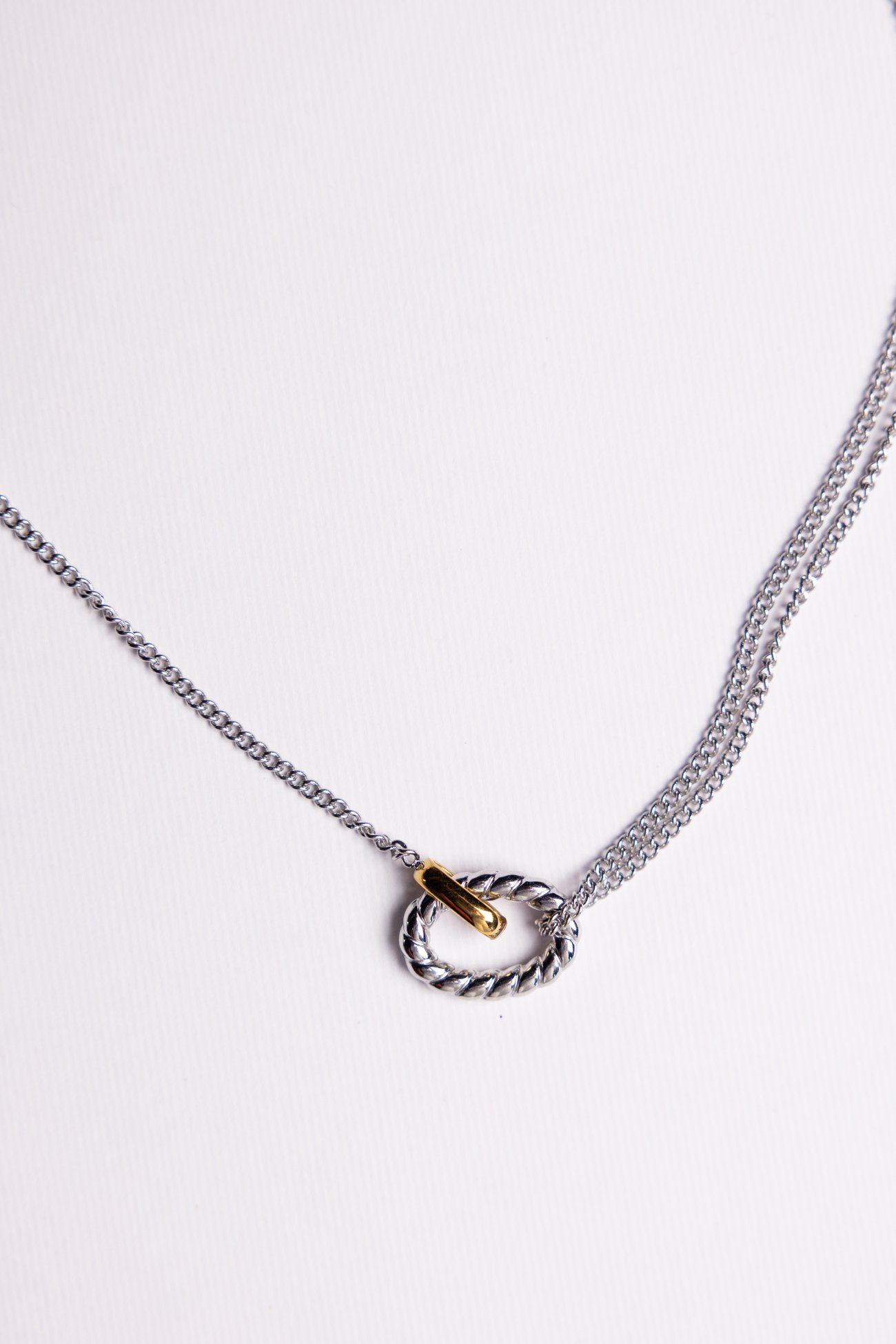 Silver curb chain necklace with twisted ring and gold bar clasp