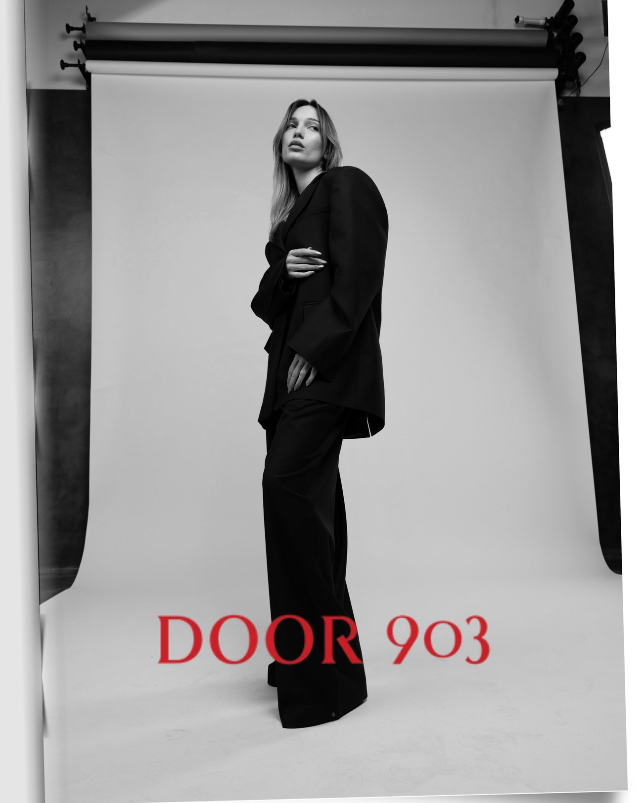 Black and white editorial portrait with the red DOOR 903 logo