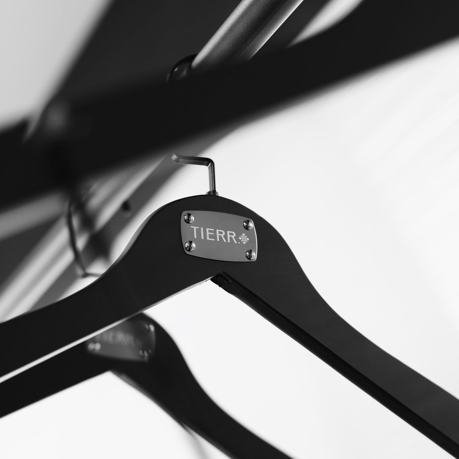 Black TIERR hanger with a metal logo plate