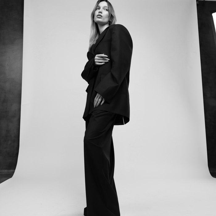 Black and white editorial portrait of the oversized DOOR 903 suit