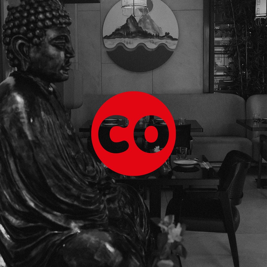 Sushi Co CO mark over a black and white shot of the dining room