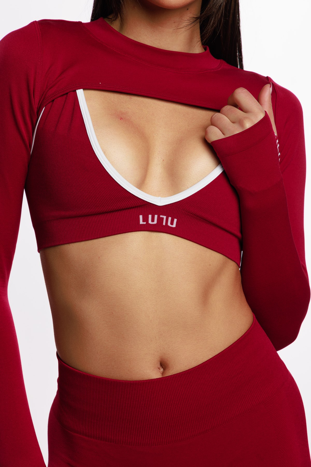 Close-up of the red LULU cut-out crop top with the logo on the bra band