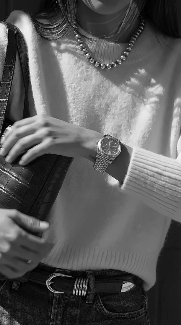 Black and white photo of a wrist wearing a watch with Select Watches wordmark