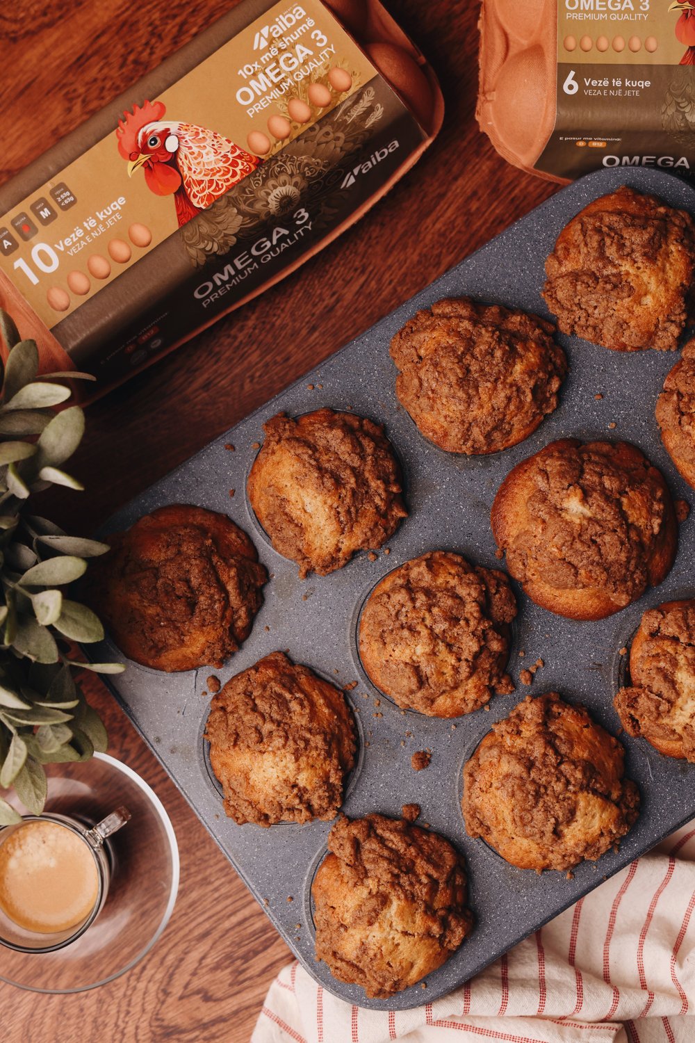 Cinnamon crumble muffins in a tray with AIBA Omega 3 cartons and coffee