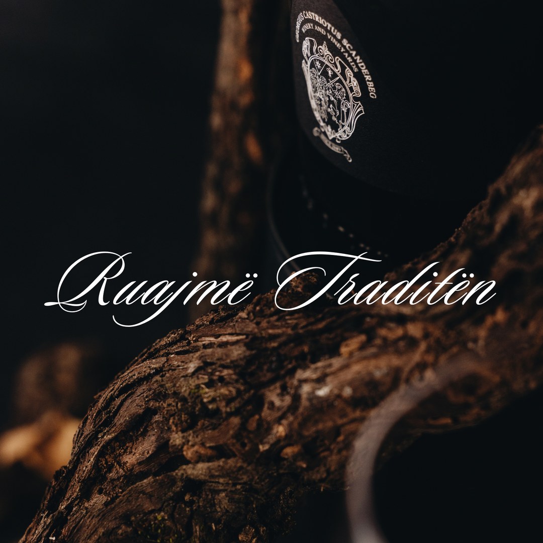 Ruajmë Traditën: the crest on a bottle against an old vine